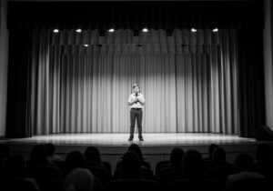A shy student performing on stage during a school competition
