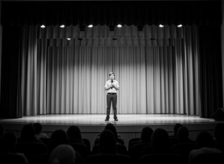 A shy student performing on stage during a school competition